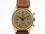 une photo d'une montre dorée et marron, dotée d'un bracelet en cuir marron