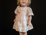 a small doll that is standing on a black surface