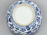 blue and white porcelain bowl with floral design on the rim