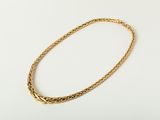 a gold necklace on a white background