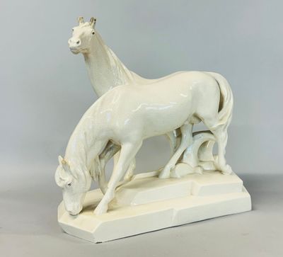 sculpture en porcelaine représentant un cheval et un poulain sur un socle blanc