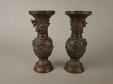 two vases that are sitting on a table