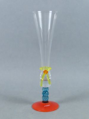 a clear glass vase with a red base and a yellow base