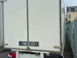 a white truck that is parked on the side of the road