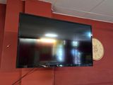 une télévision à écran plat fixée au mur au-dessus d'un canapé