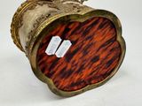 a gold and tortoise shell box with tags on it