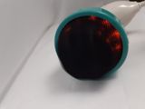 a close up of a toothbrush with a red light on it