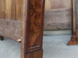 a wooden bed with a carved headboard and foot board