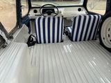 two seats in the back of a truck with blue and white stripes