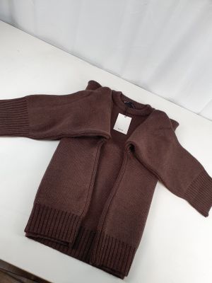 the sweater is brown and has a white tag on it