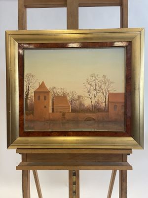 painting on easel with a painting of a house in the background
