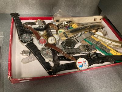 a red box with a bunch of watches in it