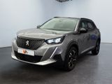 the front view of a silver suv parked in a showroom