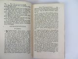 an open book on a white table with a black and white picture