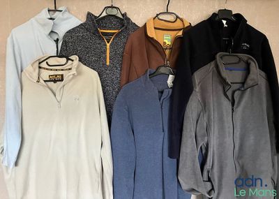 a lot of sweaters hanging on the wall