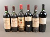several bottles of wine are lined up on a table