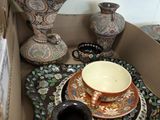 many vases and plates in a box on the table