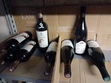 several bottles of wine are lined up on a shelf in a wine cellar