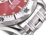a close up of a wrist watch with a red dial