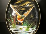a plate with a painting of a duck on it