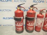 several fire extinguisors are lined up on a table