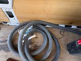 a vacuum and a hose on the floor next to a piece of wood