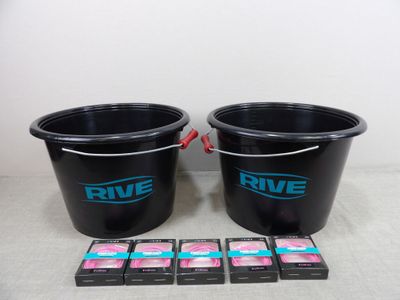 two black buckets filled with pink and blue soap sitting next to each other