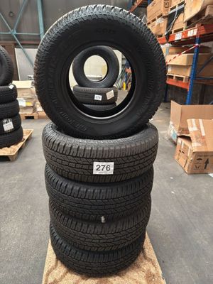 tires stacked on pallets in a warehouse with boxes and pallets