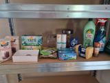 a shelf that has many different types of cleaning products on it