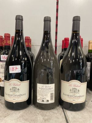 several bottles of wine are lined up on a counter