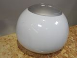 a white ball with a silver top sitting on a table