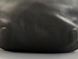 a close up of a black leather bag with the word love written on it