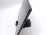 a black laptop sitting on a stand on a white surface