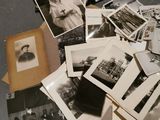 a pile of old black and white photos on a table