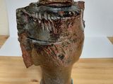 a brown vase that is sitting on a wooden table