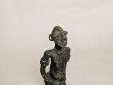 an image of a statue of a woman sitting on a white surface
