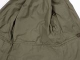 the back of a green jacket with a white tag on it