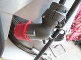 a black pipe with a red stopper attached to it