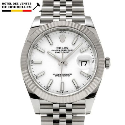 a close up of a wrist watch with a white dial