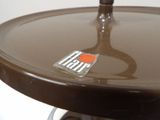 a close up picture of a brown table with a sticker on it