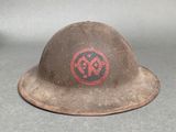 an old helmet with a red and black symbol on it
