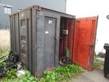 a black container with a red door next to a trash can
