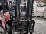 a fork lift truck that is parked in a lot