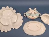 three plates and a bowl sitting on a blue table