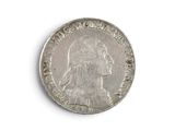 an old silver coin on a white surface with a white background