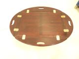 an image of a round wooden tray with holes in it