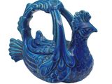 a blue vase with a bird on it on a white background