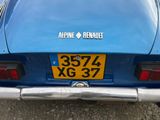 a blue car that is parked on the side of the road