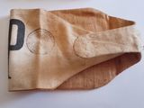 a paper bag with a pair of scissors next to it