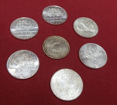 six different coins on a red cloth with a red background